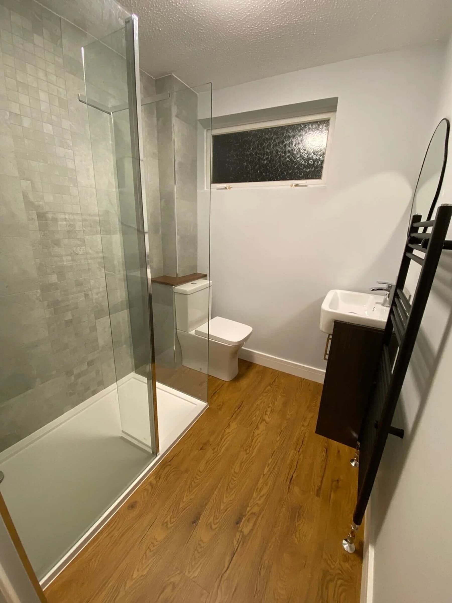 Modern grey bathroom with backlit mirror